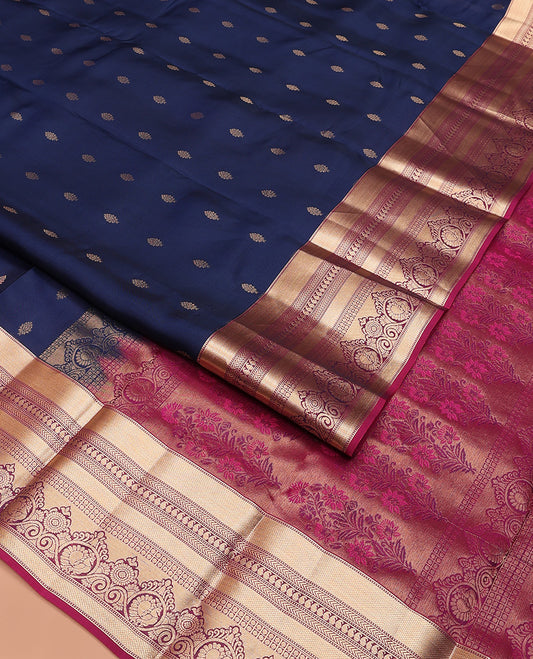 Navy blue zari buttas Vasundhara silk mix saree, contrast border of muthu, kuyil kann, kathir, manga, and mayil chakram designs, and floral design pallu