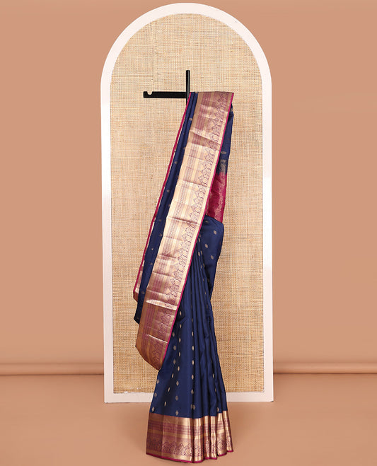 Navy blue zari buttas Vasundhara silk mix saree, contrast border of muthu, kuyil kann, kathir, manga, and mayil chakram designs, and floral design pallu