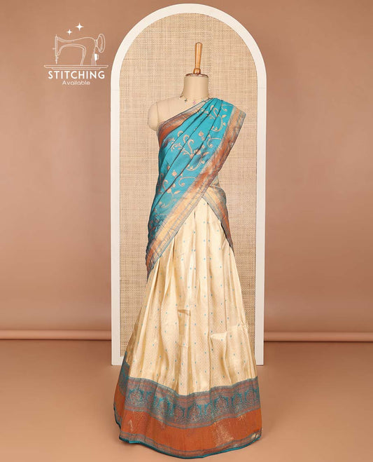 Cream buttas banaras half saree with contrast traditional zari design border, zari design blouse & light blue floral vine design dhavani