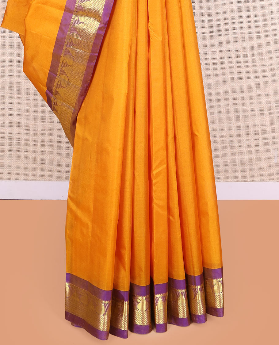 Yellow Kanchipuram Silk Saree, Subtly Sparkled with Zari Buttas, a Contrast Border of Thazampoo Rekku, Muthu, Manga, and Mayil Kann Designs, Zari Pallu, and a Contrast Blouse
