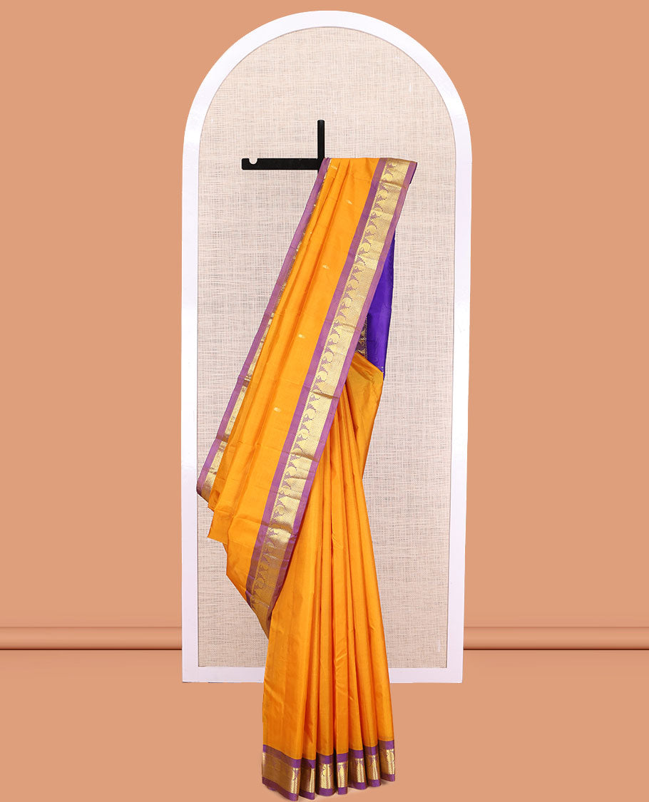Yellow Kanchipuram Silk Saree, Subtly Sparkled with Zari Buttas, a Contrast Border of Thazampoo Rekku, Muthu, Manga, and Mayil Kann Designs, Zari Pallu, and a Contrast Blouse