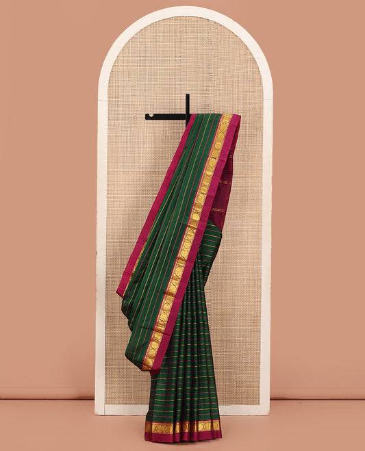 Green Kanchipuram Silk Saree Ornamented with Resham Threads Neli Stripes, Adorned with Contrast Kal Erangina Border Featuring Thilakam Mokku, Banaras, and Poun Designs, Sparsely Woven Pallu, and Paired with a Contrast Blouse