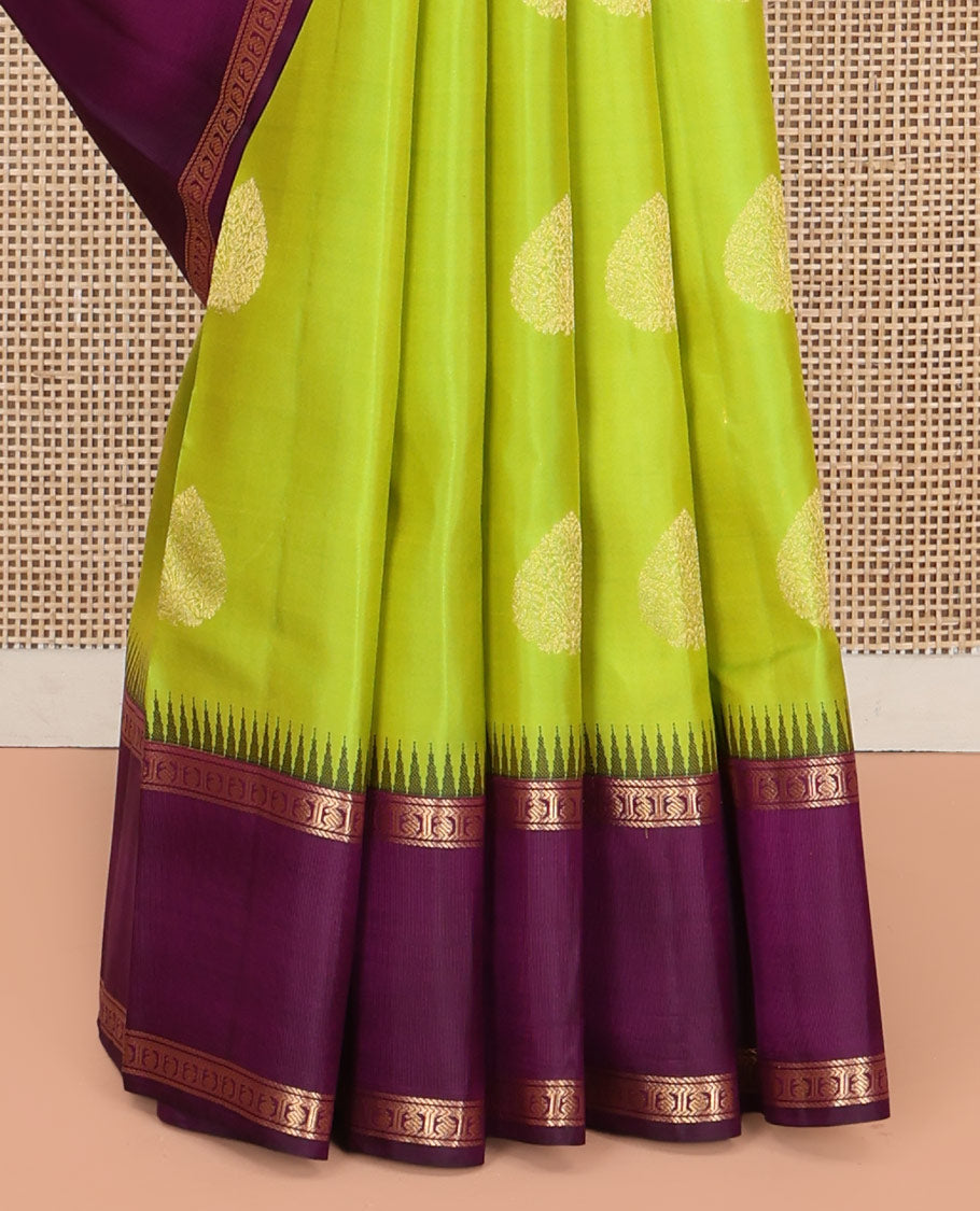 Green Vasundhara Silk Saree, Delicately Woven with Zari Buttas All Over Its Body, Complemented by a Contrast Rettai Pettu Temple Border of Banaras, and Manga Designs, Grand Jaal Pallu, and Paired with a Contrast Blouse