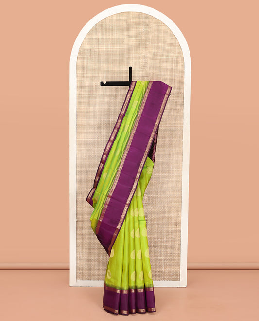 Green Vasundhara Silk Saree, Delicately Woven with Zari Buttas All Over Its Body, Complemented by a Contrast Rettai Pettu Temple Border of Banaras, and Manga Designs, Grand Jaal Pallu, and Paired with a Contrast Blouse