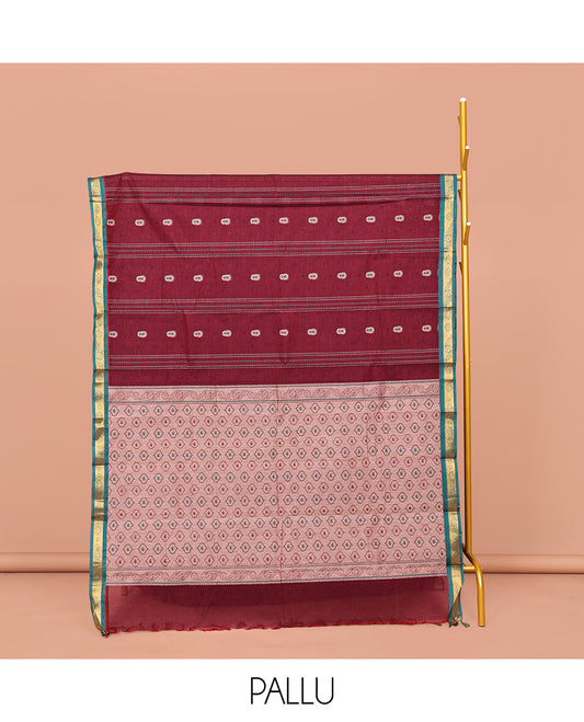 Maroon Kanchi Cotton Saree, Adorned with Buttas and Stripes on Its Body, Complemented by Contrast Zari Border, a Pallu of Jaal Designs, and Paired with a Matching Blouse