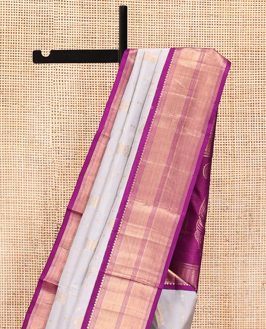 Grey Vasundhara Silk Saree, Adorned with Zari Buttas All Over Its Body, Complemented by a Contrast Border of Thilakam Mokku, Muthu, Vanki, and Mayil Kann Designs, Grand Manga Design Pallu, and Paired with a Contrast Blouse