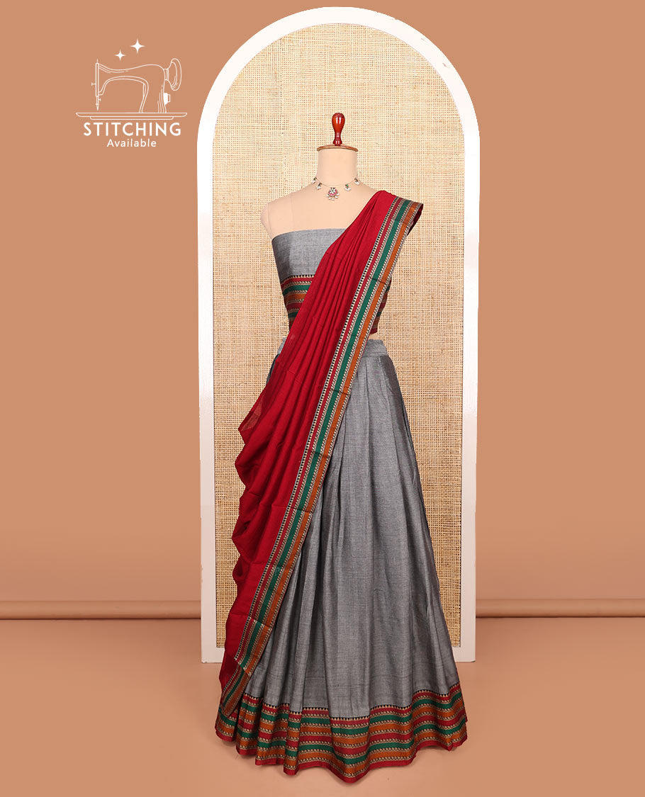 Grey plain cotton half-saree with contrast traditional motifs woven thread bordered skirt, matching blouse, and a contrast traditional bordered dhavani