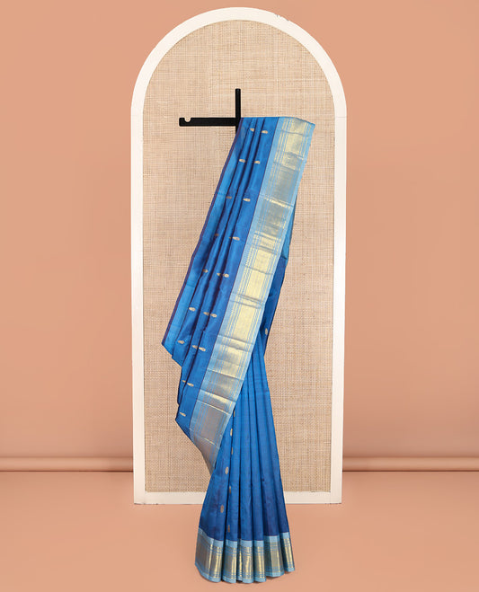 Blue Kanchipuram Silk Saree, Beautified with Zari Buttas on Its Body, Complemented by a Contrast One-Sided Border of Panner Sombu, Banaras, Muthu, and Jaal Designs, Pallu Depicts Zari Designs, and Comes Without a Blouse