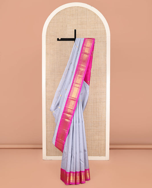 Grey Kanchipuram Silk Saree, Enthralled with Zari Buttas on Its Body, Complemented by a Contrast One-Sided Korvai Border of Rekku, Banaras, and Mayil Kann Designs, Pallu Steeped with Zari Designs, and Comes Without a Blouse