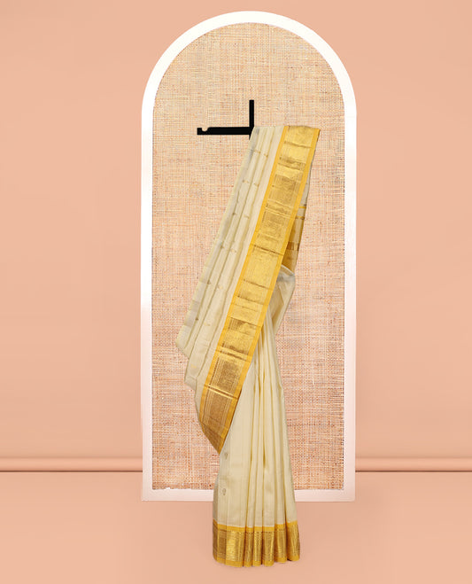 Sandal Kanchipuram Silk Saree, Subtly Sparkled with Zari Buttas, a Contrast One-Sided Border of Thilakam Mokku, Banaras, Muthu, and Jaal Designs, Zari Design Pallu, and No Blouse
