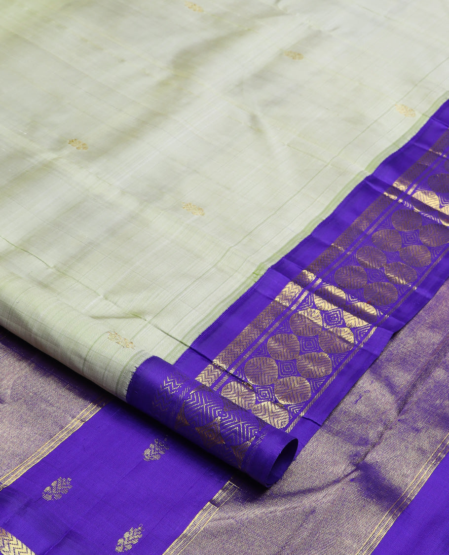 Pastel green zari buttas Kanchipuram silk saree, contrast korvai one-sided border of vanki, and poun designs, and zari decked up pallu
