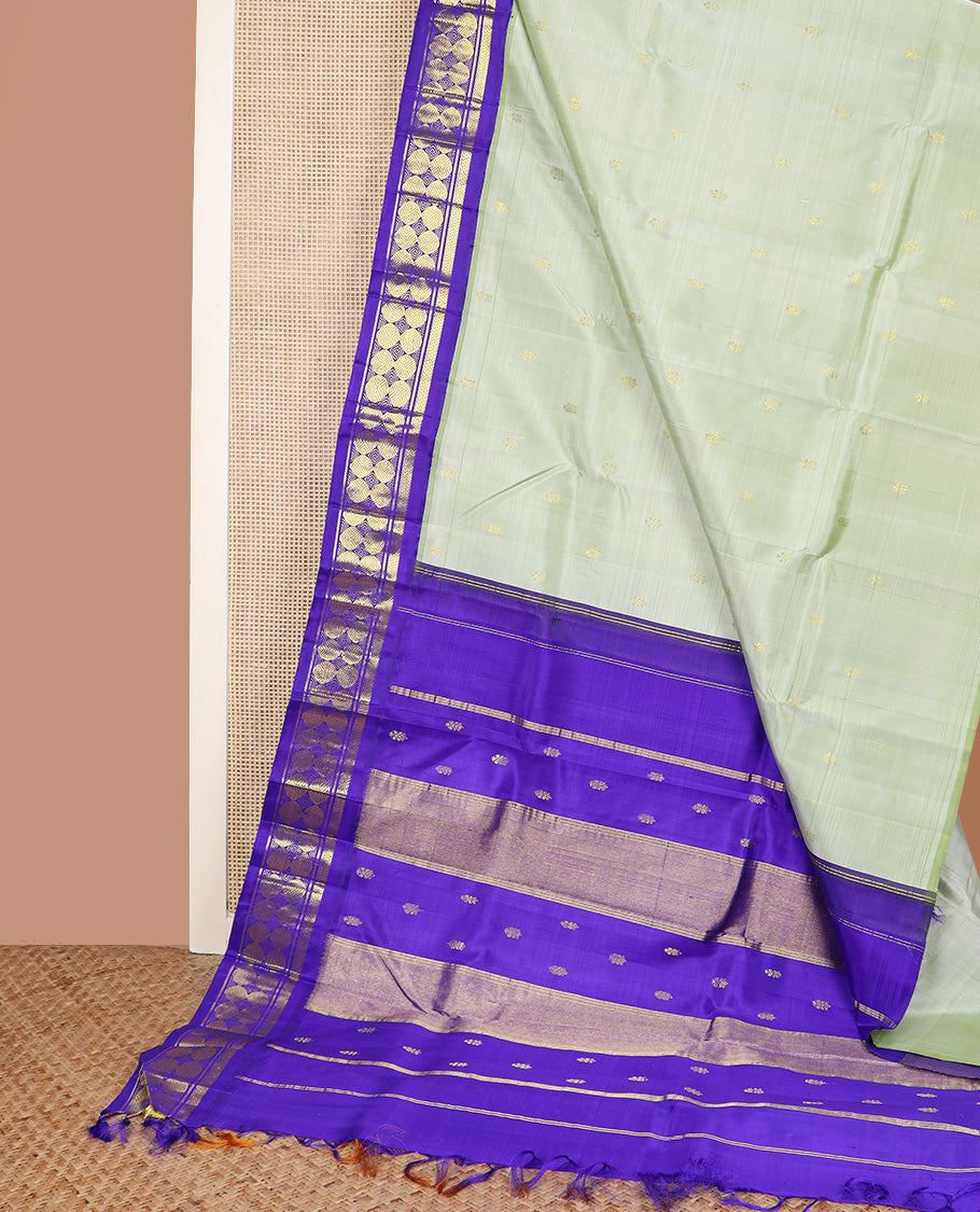 Pastel green zari buttas Kanchipuram silk saree, contrast korvai one-sided border of vanki, and poun designs, and zari decked up pallu