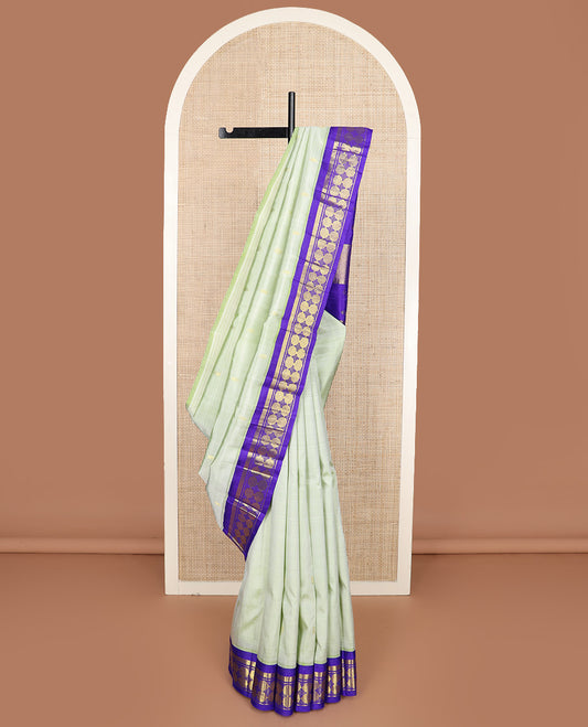 Pastel green zari buttas Kanchipuram silk saree, contrast korvai one-sided border of vanki, and poun designs, and zari decked up pallu