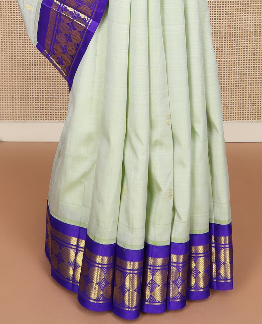 Pastel green zari buttas Kanchipuram silk saree, contrast korvai one-sided border of vanki, and poun designs, and zari decked up pallu