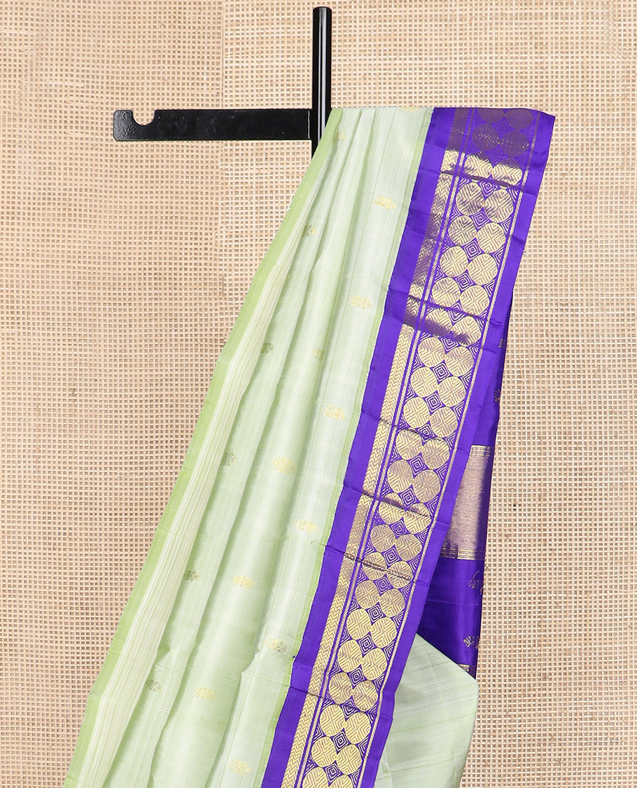 Pastel green zari buttas Kanchipuram silk saree, contrast korvai one-sided border of vanki, and poun designs, and zari decked up pallu