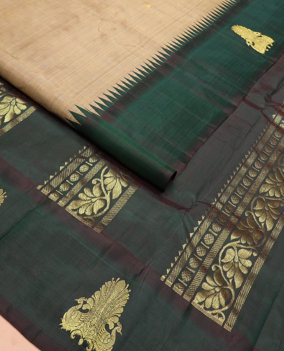Brown zari buttas Kanchipuram silk saree, contrast thazampoo rekku border of mayil designs, and pallu of rekku, rudraksham, and kodi visiry designs