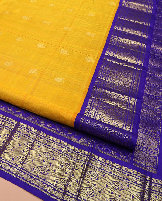 Yellow Kanchipuram Silk Saree Subtly Sparkled with Zari Buttas All Over Its Body, Complemented by a Contrast One-Sided Korvai Border of Manga Mokku, and Jaal Designs, Majestically Woven Pallu of Floral Jaal Designs, and Comes Without a Blouse