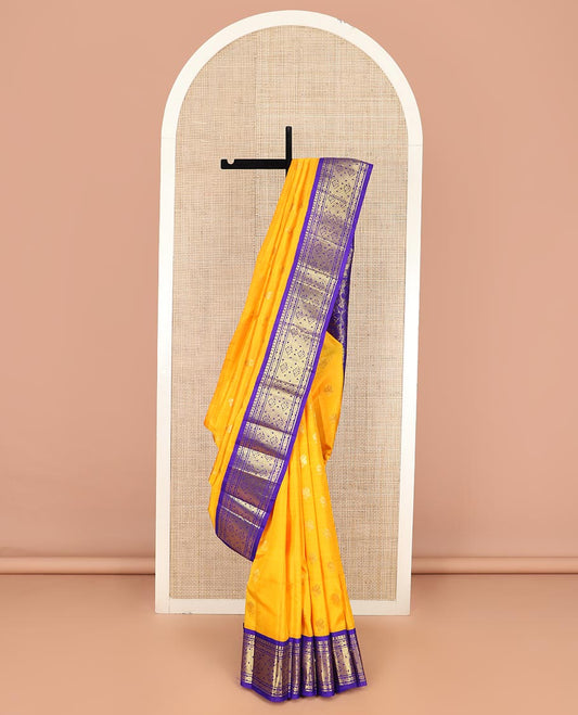 Yellow Kanchipuram Silk Saree Subtly Sparkled with Zari Buttas All Over Its Body, Complemented by a Contrast One-Sided Korvai Border of Manga Mokku, and Jaal Designs, Majestically Woven Pallu of Floral Jaal Designs, and Comes Without a Blouse