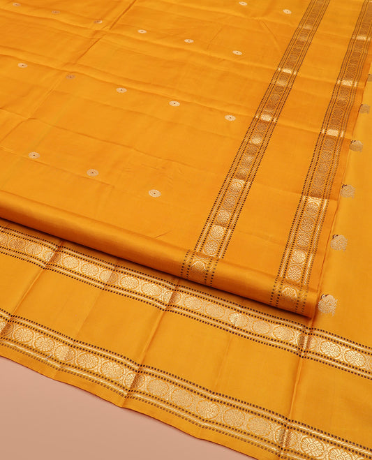 Yellow Kanchipuram Silk Saree Elevated with Chakram Buttas on Its Body, Highlighted by a Self-Border of Muthu, Banaras, and Chakram Designs, Pallu Artfully Woven with Meenakari Annam Chakram Designs, and Paired with a Matching Blouse