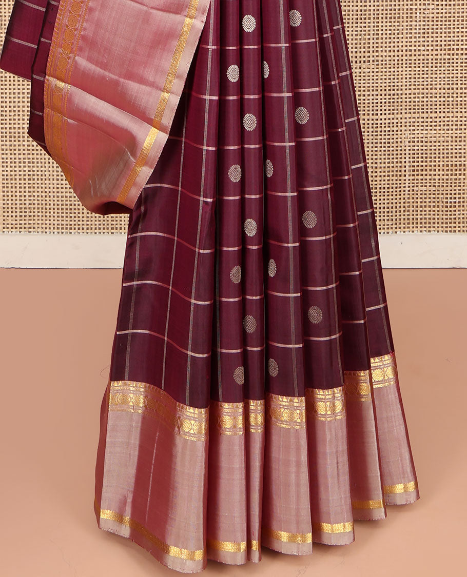 Maroon Kanchipuram Silk Saree, Richly Detailed with Chakram Buttas Enclosed Checks, Complemented by a Contrast Rettai Pettu Border of Rekku, Banaras, Muthu, and Poun Designs, Pallu Steeped with Chakram Motifs, and Paired with a Contrast Blouse