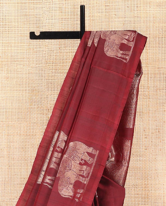 Borderless Maroon Mayuri Soft Silk Saree, Beautifully Bedecked with Vrishabha-Kunjara Buttas, Highlighted by Pallu of Vrishabha-Kunjara and Geometric Designs, and Paired with Matching Blouse