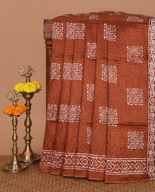Rust batik-printed square motifs Litchi crushed saree, batik-printed border & pallu of geometric & floral batik print