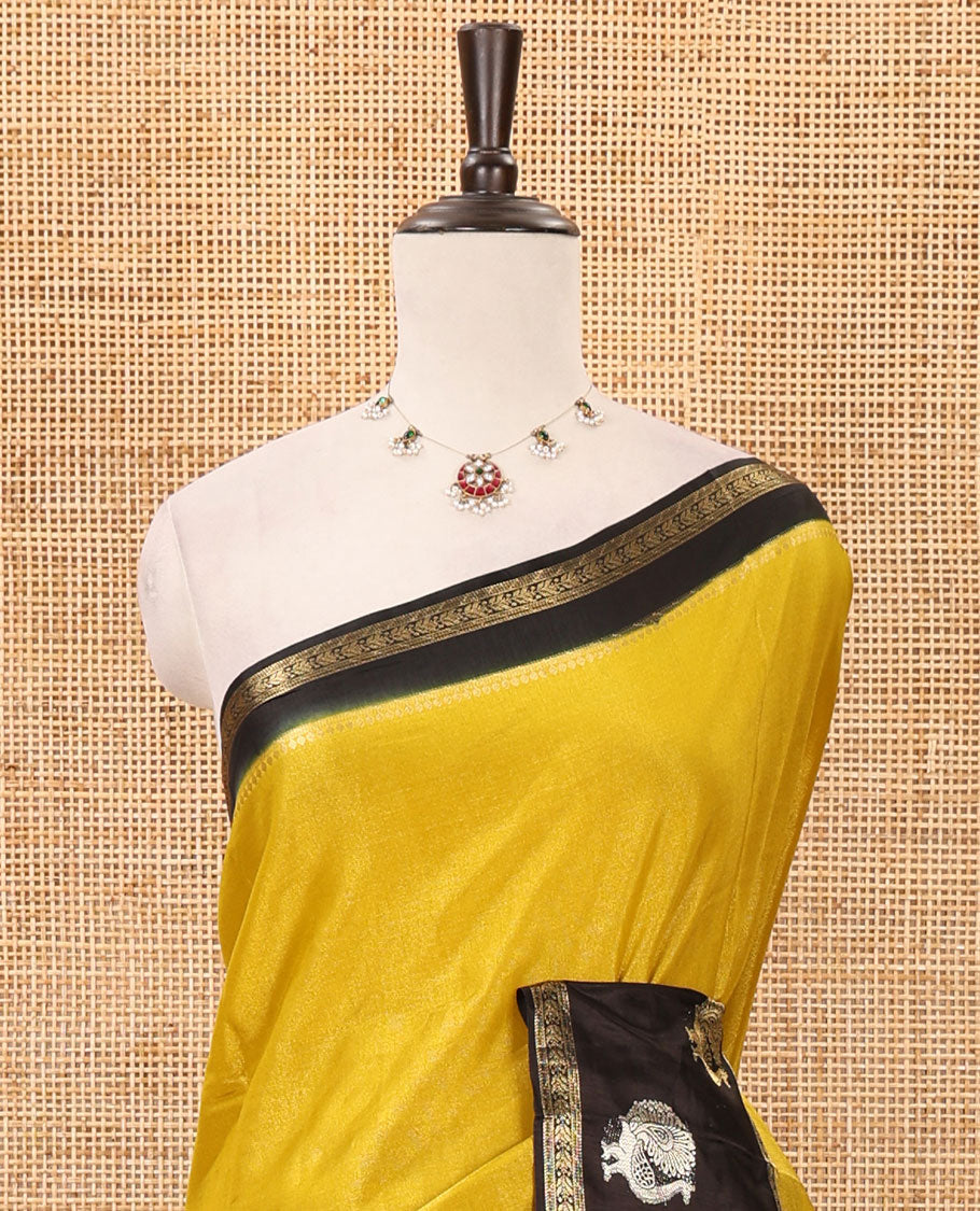 Mustard plain Banarasi tissue silk saree, contrast traditional zari peacock border, zari striped pallu & floral jaal jacquard black blouse