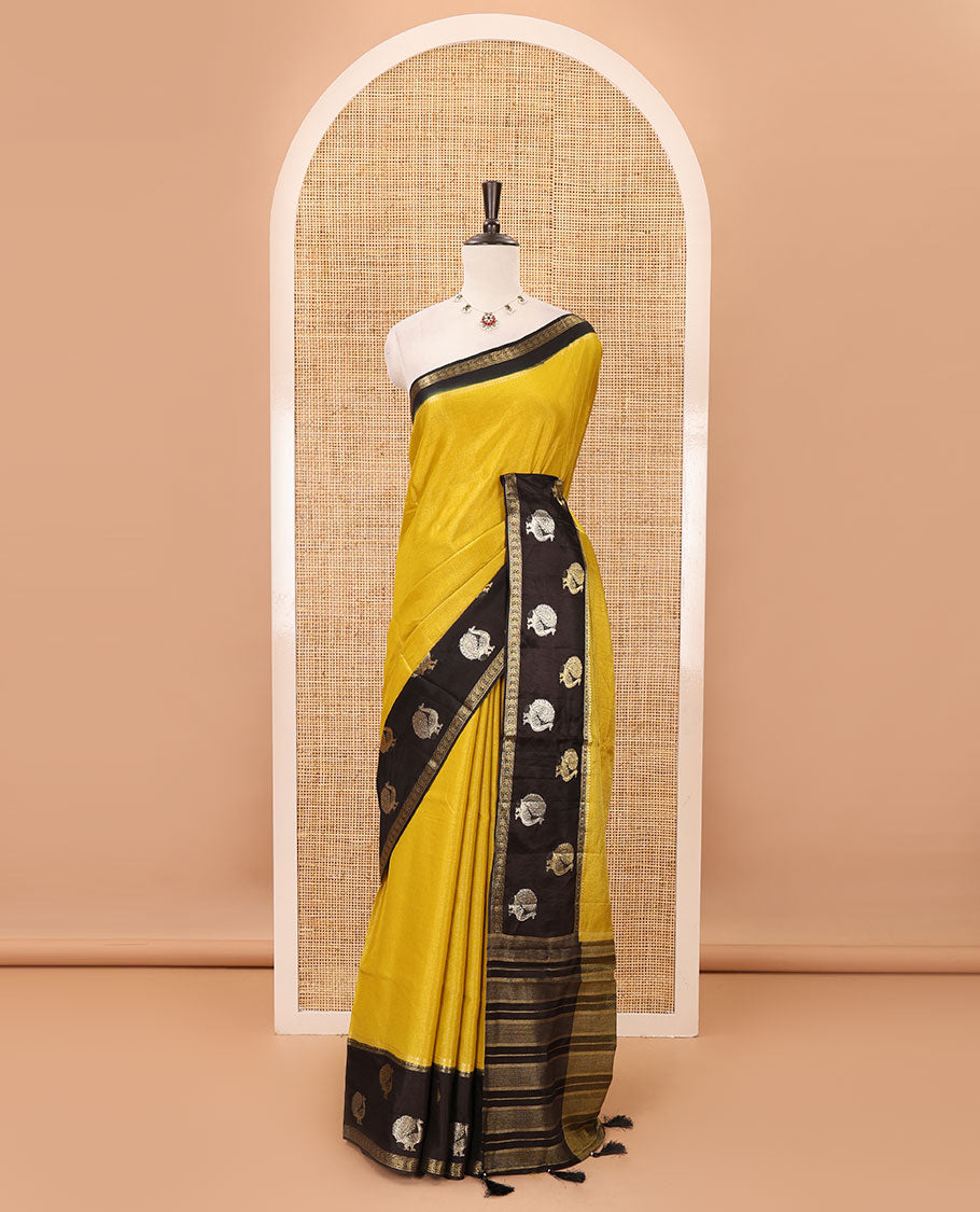Mustard plain Banarasi tissue silk saree, contrast traditional zari peacock border, zari striped pallu & floral jaal jacquard black blouse