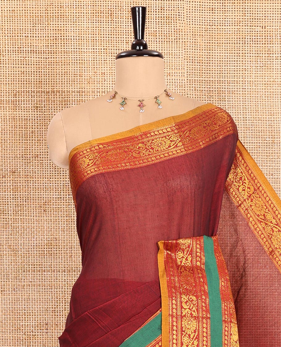 Maroon Plain Mercerised Cotton Saree Artfully Detailed with a Contrasting Rettai Pettu Border Featuring Peacock Motifs in Zari, a Subtly Striped Pallu, and a Matching Blouse