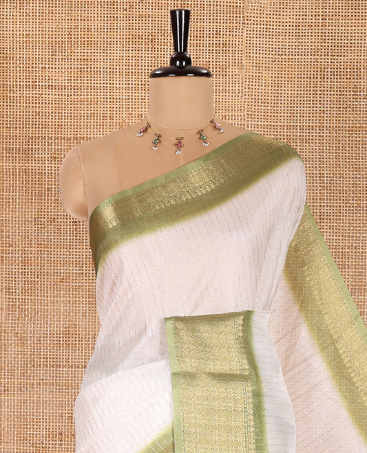 White and Green Dola Silk Saree Elevated with Vertical Zari Stripes All Over the Body, Complemented by a Contrast Border of Traditional Zari Designs, Self-Pallu of Stripes, and Paired with a Contrast Blouse