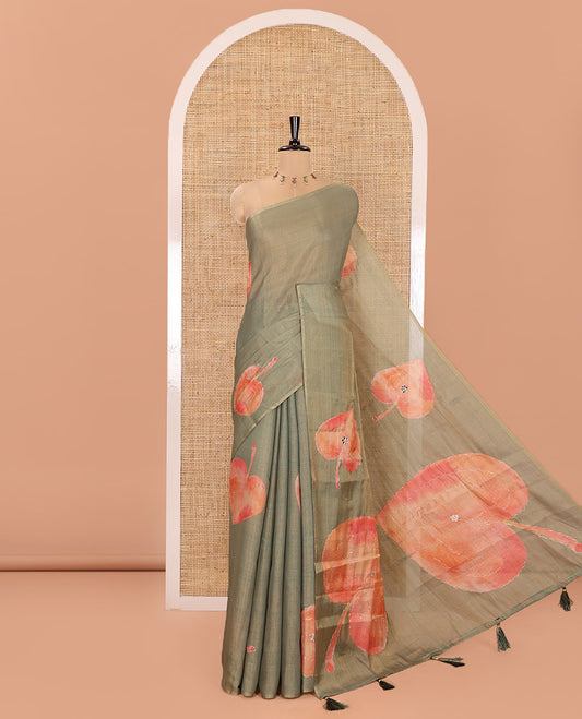 Borderless Green Tissue Saree, Elevated with Big Leaf Motifs Print, and Outline Embroidery All Over the Saree, Paired with a Subtle Leaf Motifs Printed Blouse