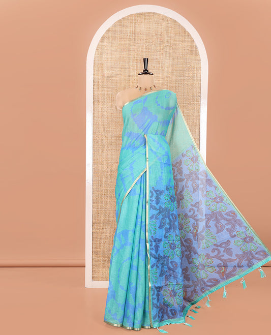 Rama Green Linen Cotton Saree, Elevated with Shibori Printed on Its Body, Subtle Piping Border, Pallu Features Floral Print, and Paired with a Contrast Floral Printed Blouse