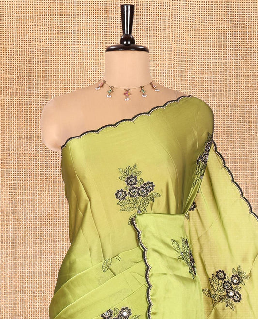Green Rangoli Chiffon Saree, Elevated with Flower-Style Motifs Embroidered on Its Body, a Subtle Scallop Embroidered Border, a Self-Pallu, and Paired with a Contrast Embroidered Blouse