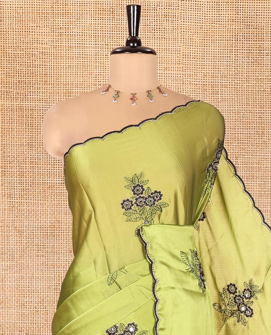 Green Rangoli Chiffon Saree, Elevated with Flower-Style Motifs Embroidered on Its Body, a Subtle Scallop Embroidered Border, a Self-Pallu, and Paired with a Contrast Embroidered Blouse