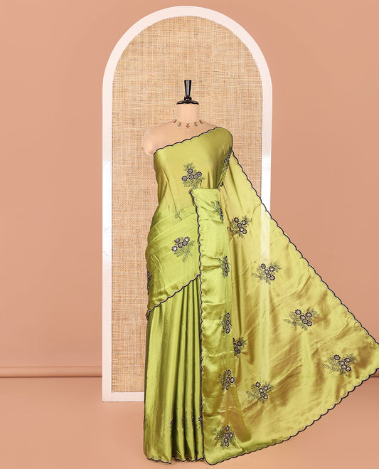 Green Rangoli Chiffon Saree, Elevated with Flower-Style Motifs Embroidered on Its Body, a Subtle Scallop Embroidered Border, a Self-Pallu, and Paired with a Contrast Embroidered Blouse