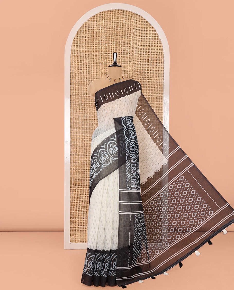 Cream and Black Linen Cotton Saree, Subtly Steeped with Raindrop Style Buttas All Over Its Body, Complemented by Contrast Ikkat Style Border of Elephant Motifs, Ikkat Style Pallu, and Paired with a Contrast Blouse
