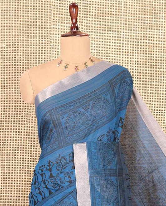Indigo Blue Semi-Silk Cotton Saree, Adorned with Warli Print, a Tissue Border, Contrast Warli Printed Pallu, and a Contrast Blouse