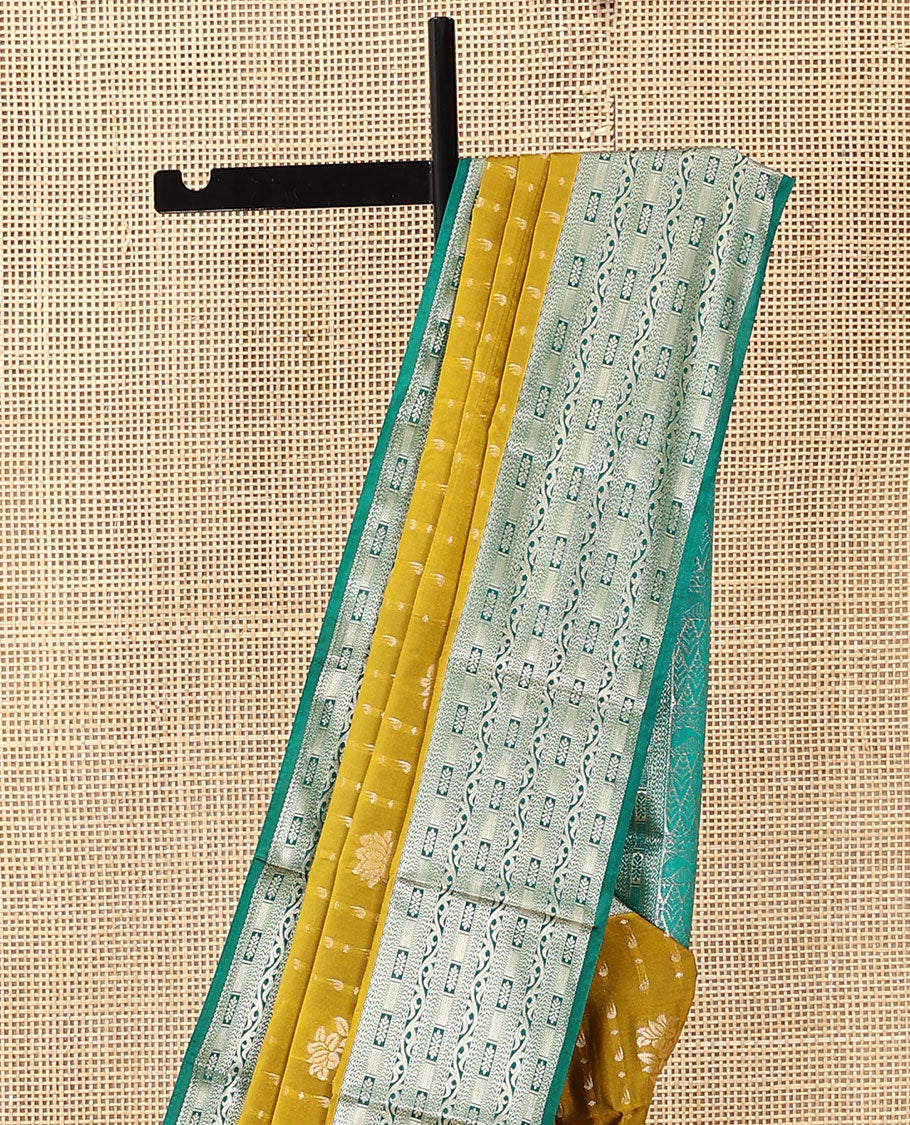 Green floral buttas soft silk saree, contrast traditional zari design border, and pallu of geometric patterns