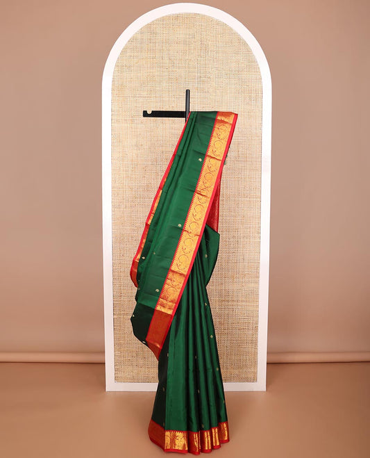 Dark green Green floral buttas silk saree with contrast border of thilakam mokku, muthu, banaras, mayil design & zari design pallu