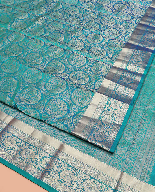 Peacock Blue Kanchipuram Silk Saree Opulently Embellished with Jacquard Design, Highlighted with Zari Border of Rekku, Ogee, and Kodi Visiry Designs, Elegantly Detailed Pallu of Geometric Designs, and Paired with a Matching Blouse