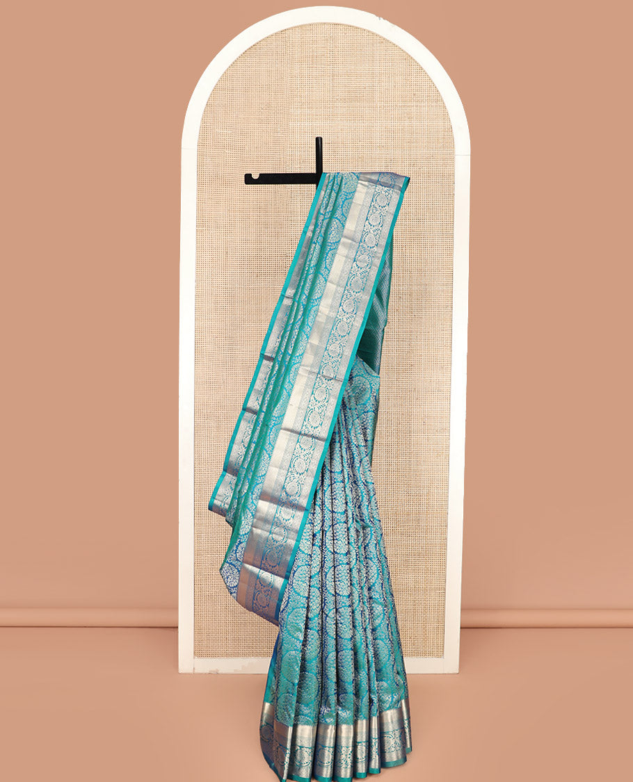 Peacock Blue Kanchipuram Silk Saree Opulently Embellished with Jacquard Design, Highlighted with Zari Border of Rekku, Ogee, and Kodi Visiry Designs, Elegantly Detailed Pallu of Geometric Designs, and Paired with a Matching Blouse