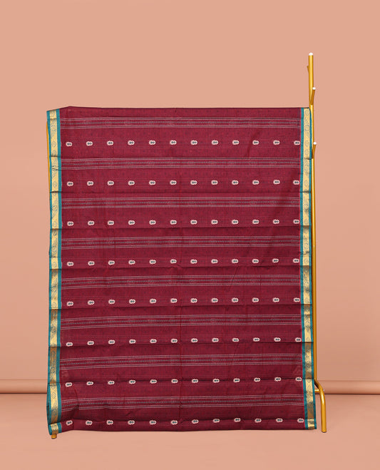 Maroon Kanchi Cotton Saree, Adorned with Buttas and Stripes on Its Body, Complemented by Contrast Zari Border, a Pallu of Jaal Designs, and Paired with a Matching Blouse