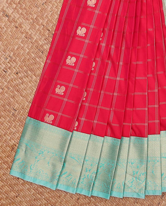 Red peacock and chakram motif enclosed checked gift saree, contrast traditional zari border, and jaal pallu