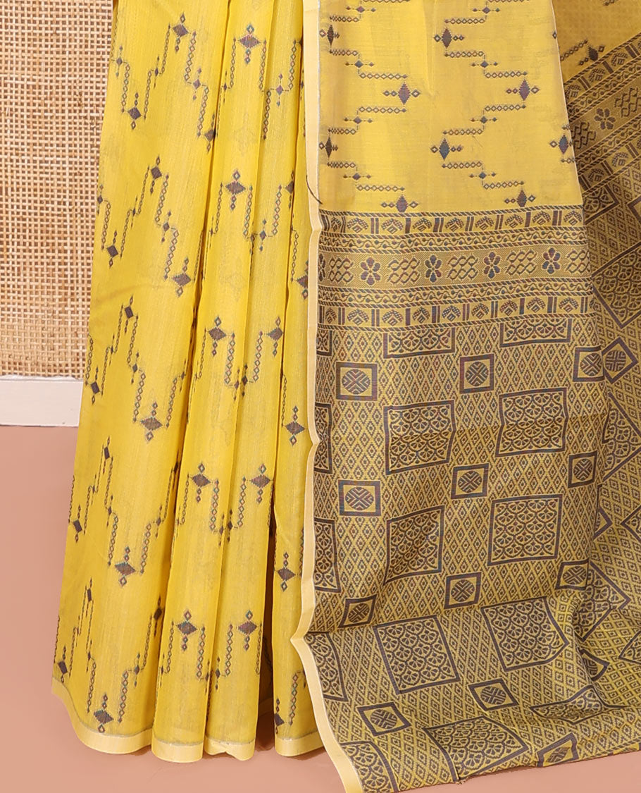 Borderless Yellow Semi-Silk Cotton Saree, Adorned with Unique Buttas on Its Body, Highlighted by Geometric-Patterned Pallu, and Paired with a Matching Blouse