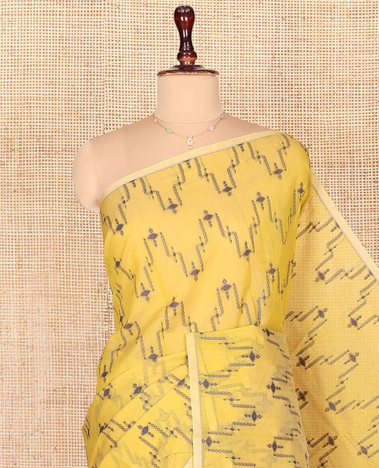 Borderless Yellow Semi-Silk Cotton Saree, Adorned with Unique Buttas on Its Body, Highlighted by Geometric-Patterned Pallu, and Paired with a Matching Blouse