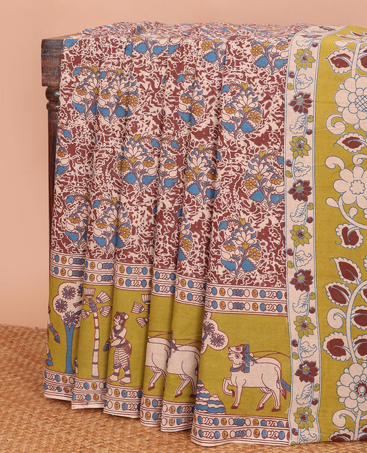Terracotta red floral machine-printed kalamkari cotton saree, contrast pichwai cow printed border & pallu of peacock-floral print