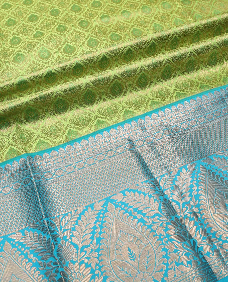 Green pure-silk half saree, jacquard with contrast traditional zari bordered skirt, blouse of thilakam mokku,poun, vanki, and thilakam designs , and zari design dhavani