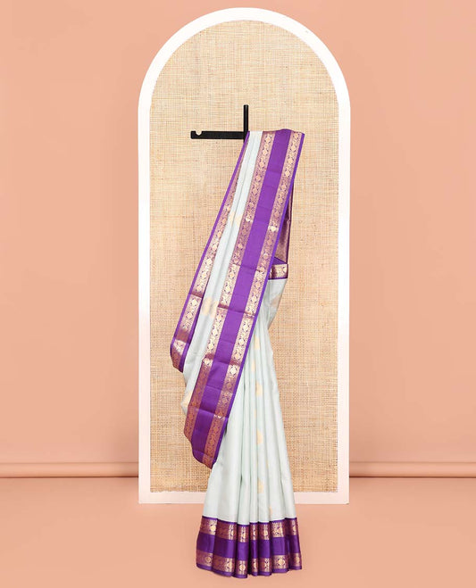 Pale Blue Vasundhara Lite Silk Mix Saree, Enriched with Zari Buttas All Over Its Body, Complemented by Contrast Korvai Border of Thilakam Mokku, Neli, Mayil, and Poun Designs, Gleaming Zari Decked Up Pallu, and Paired with a Contrast Blouse