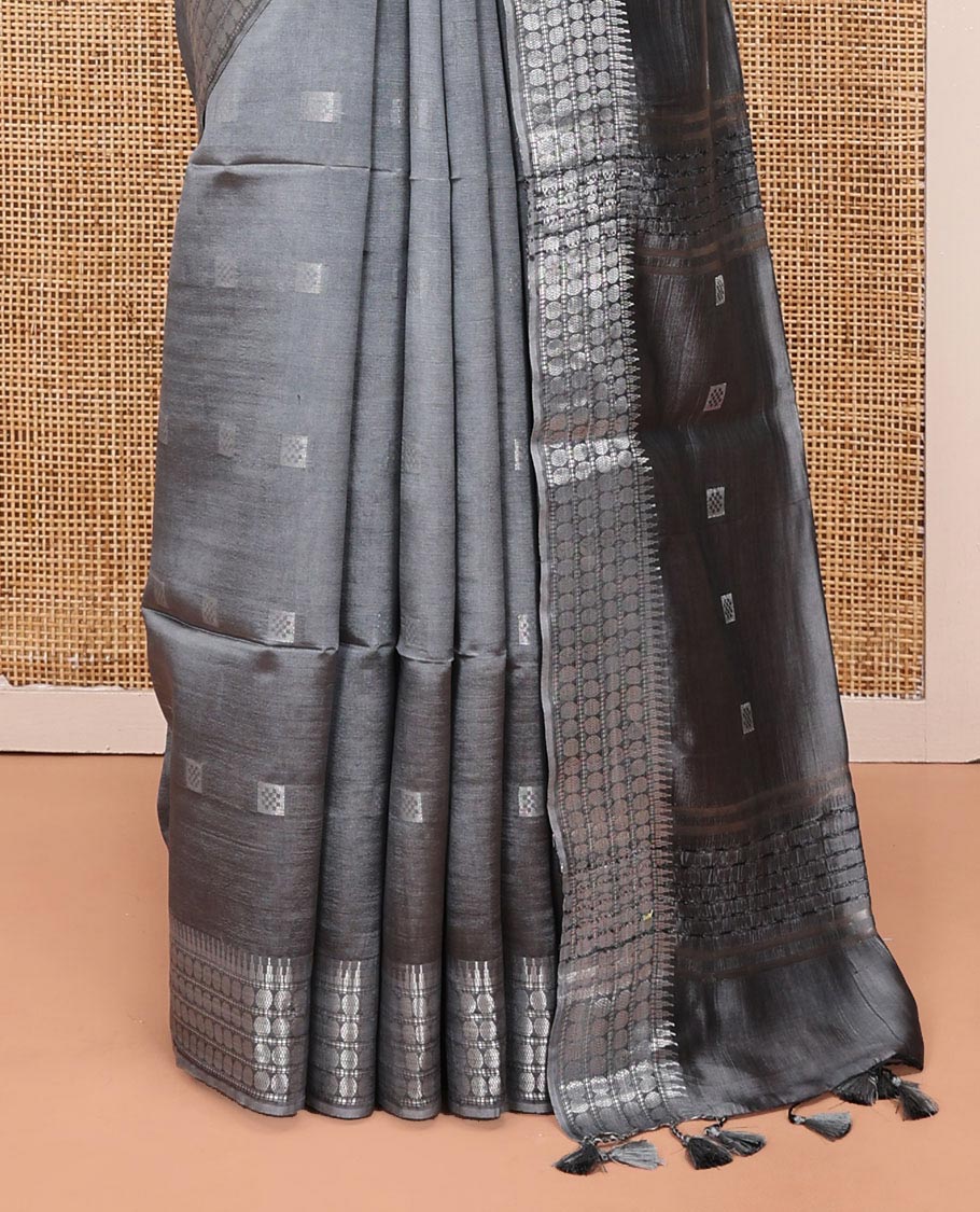 Grey Banana Pith Saree, Subtly Sparkled with Buttas All Over Its Body, Highlighted by Self-Border of Temple and Rudraksham Motifs, Pallu Steeped with Stripes and Buttas, and Paired with a Matching Blouse