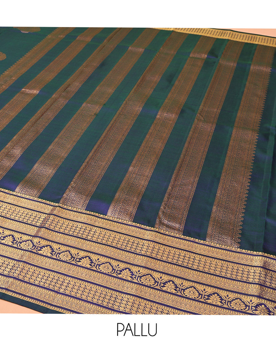 Blue Kanchipuram Silk Saree, Embellished with Mayil and Chakram Buttas All Over Its Body, Highlighted by a Zari Border of Traditional Designs, Pallu Steeped with Traditional Designs, and Paried with a Matching Blouse